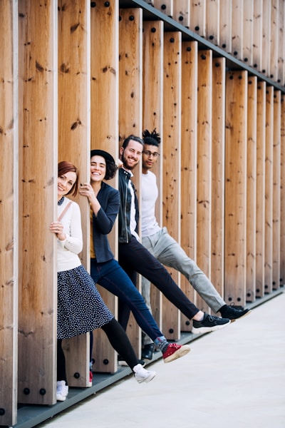 Four individuals in business attire smiling